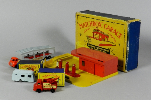 Four early Matchbox models, an early Matchbox Garage Showroom and Service Station, the model with