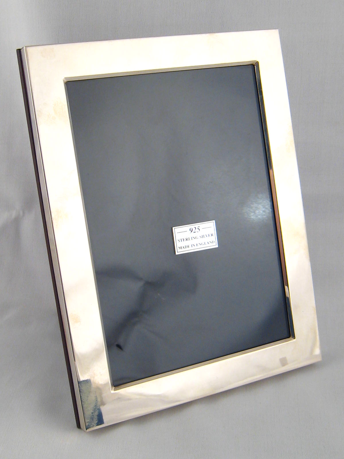 A silver photo frame with strut back, 16x21cm. in protective box.