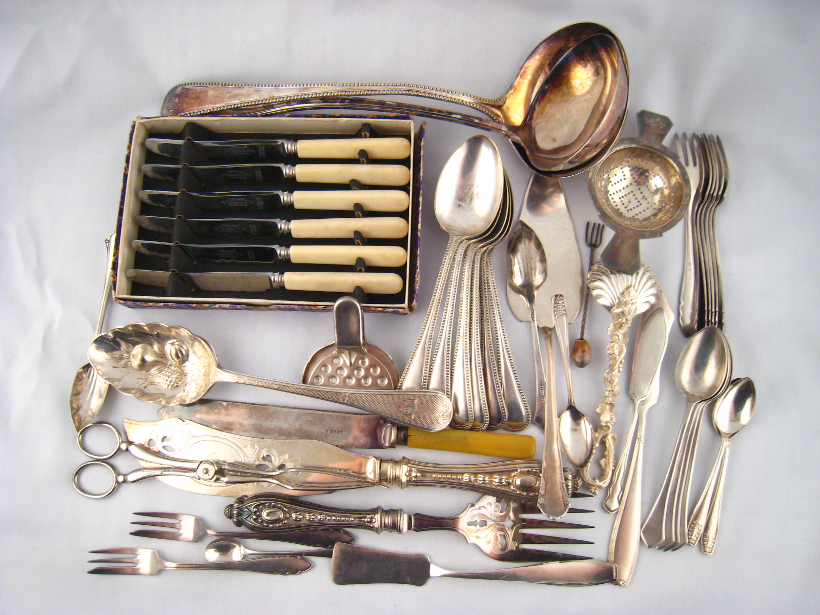 A quantity of silver plated flatware, including ladles, fish servers, pair berry spoons, sets