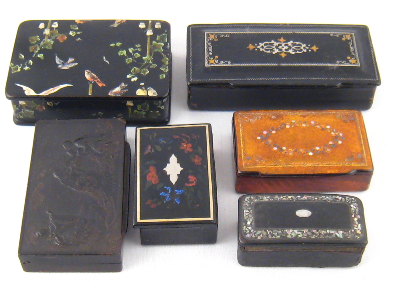 Six various composition boxes with inlaid or pressed decoration.