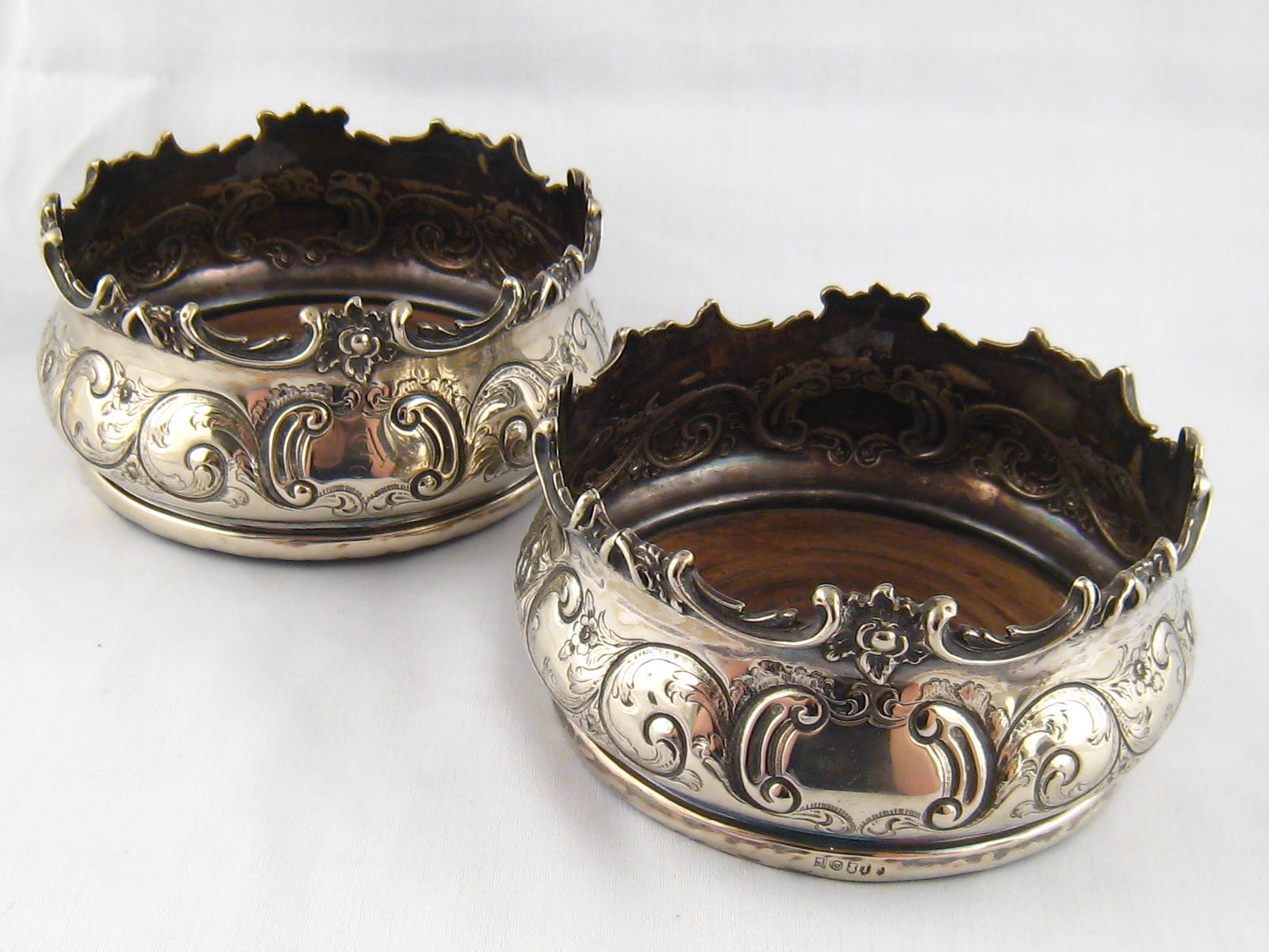 An impressive pair of heavily silver plated decanter coasters with unusual marks, unascribed, c.