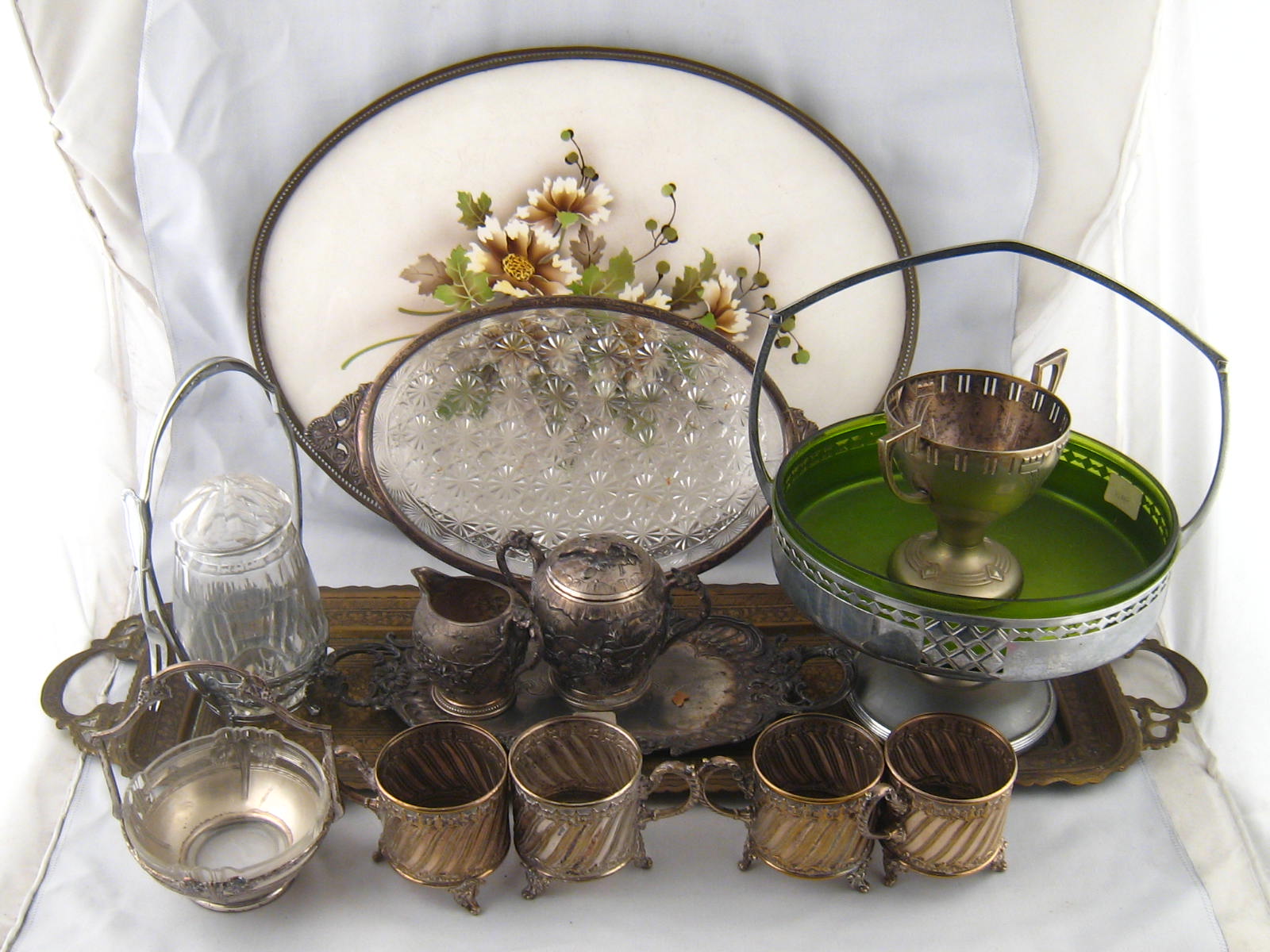 WITHDRAWN WMF : A set of four silver plated tea glass holders, a galleried oval  ceramic tray,  a
