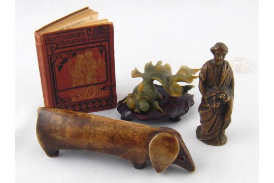 A mixed lot. A carved Chinese green hardstone fish on a leaf carved hardwood stand, a standing woman