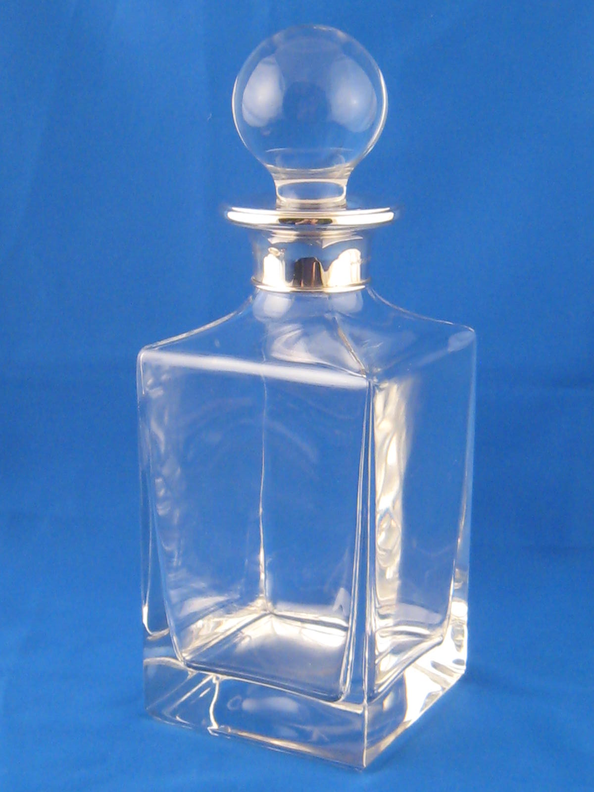 A silver mounted clear glass whisky decanter, Birmingham 2001.