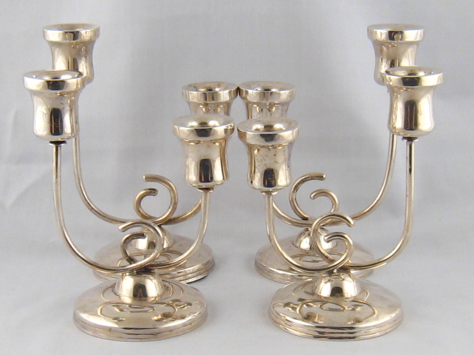 A set of four silver two light candelabra, each stamped Mexico sterling 925.wt. 1470g.