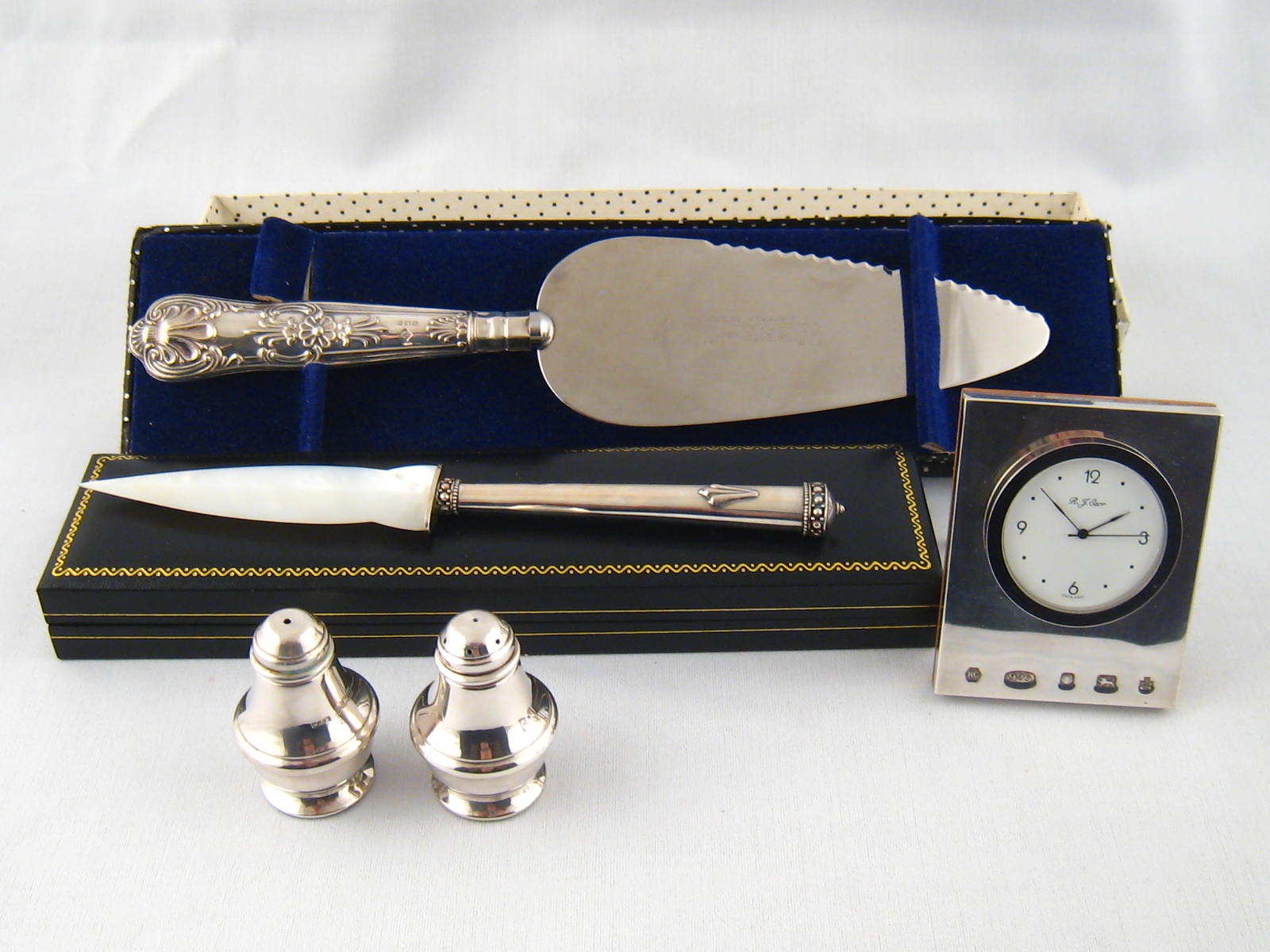 Mixed silver, comprising a silver fronted desk clock, a silver handled paperknife, silver handled