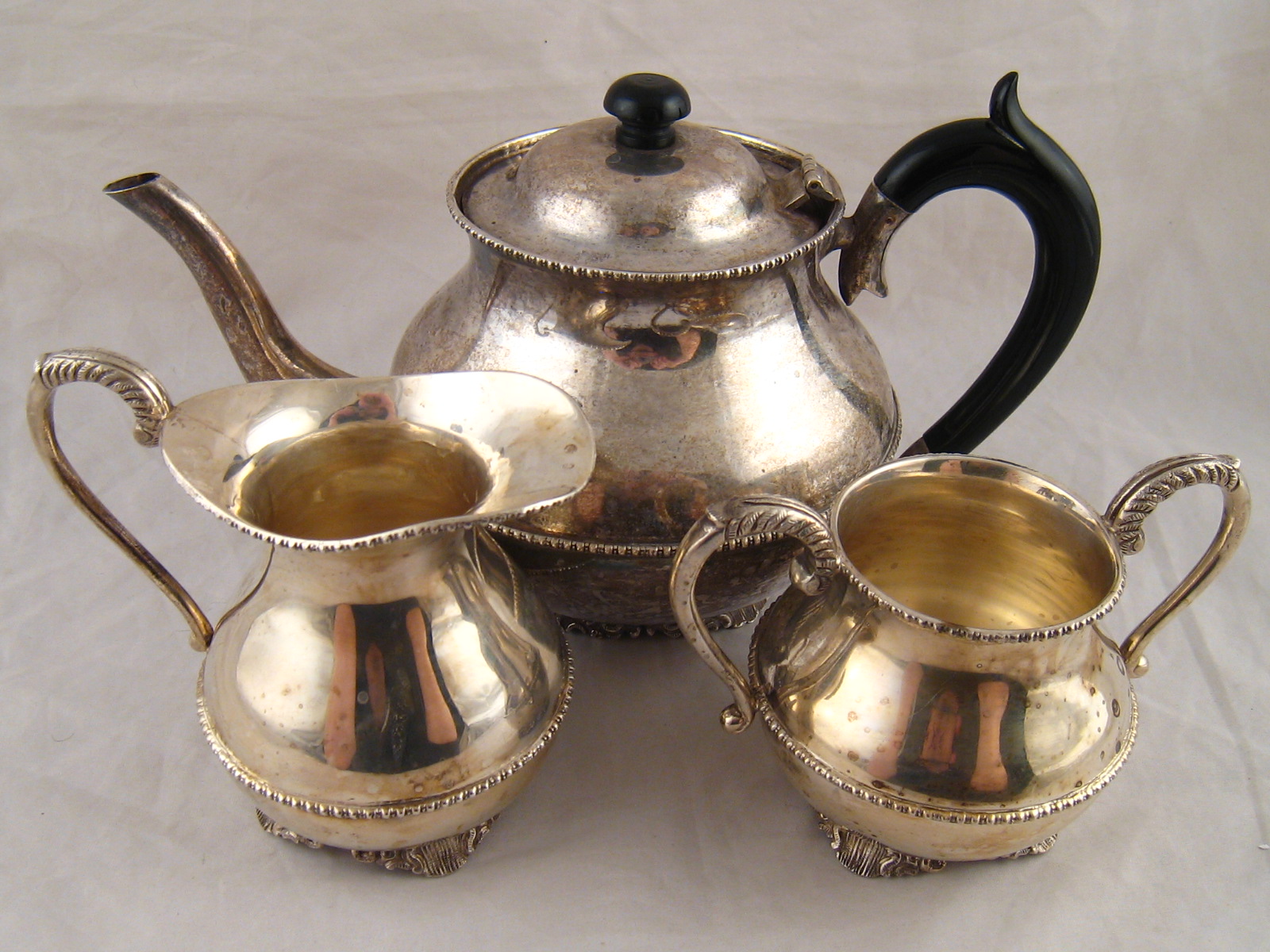A three piece tea set marked silver, wt. 1193g.