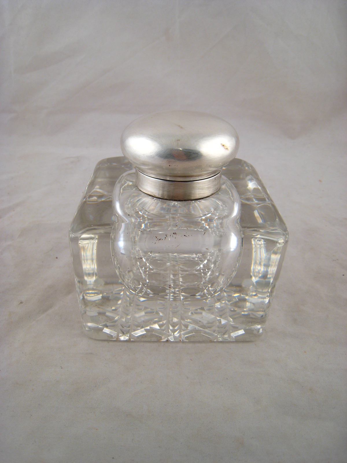 A cut glass base inkwell with silver mounts.(lid AF)