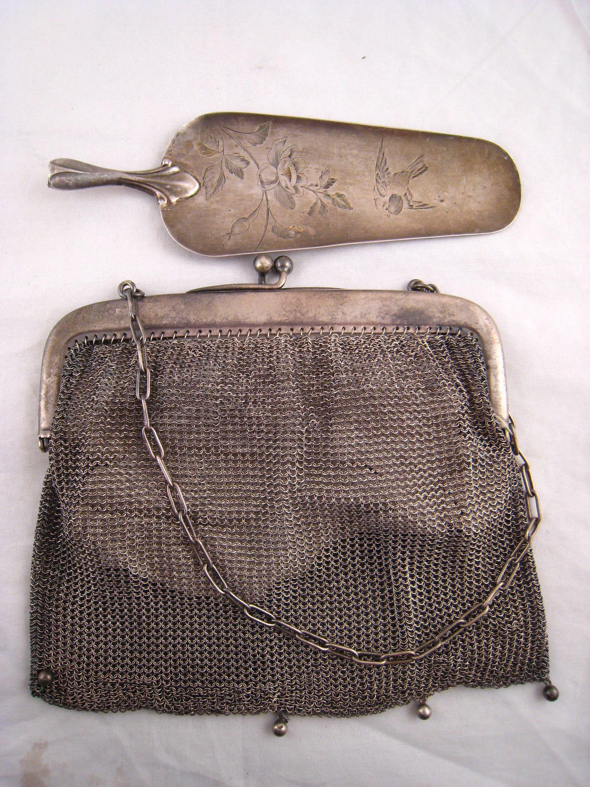 A silver, 800 grade, cake server, wt. 33g, (missing handle), and a silver plated mesh purse.