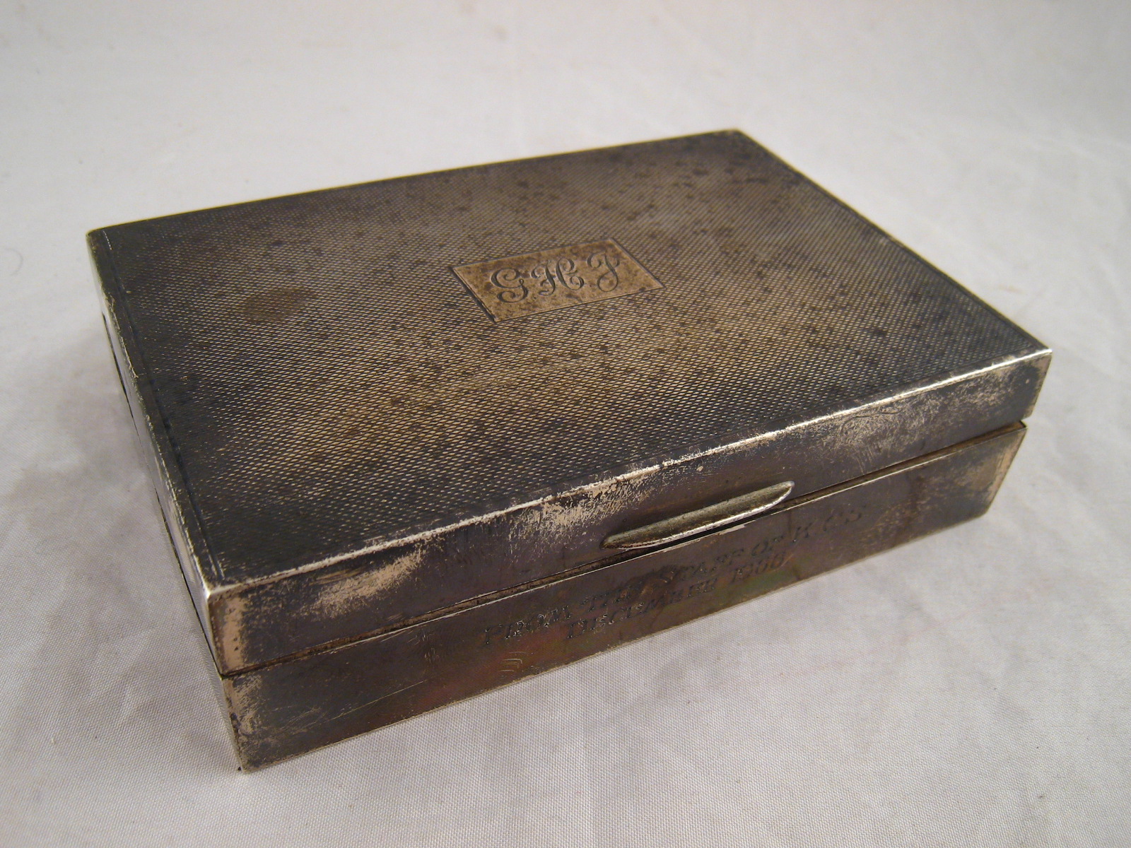 A silver cigarette box with engine turned finish. 13x9x3cm.