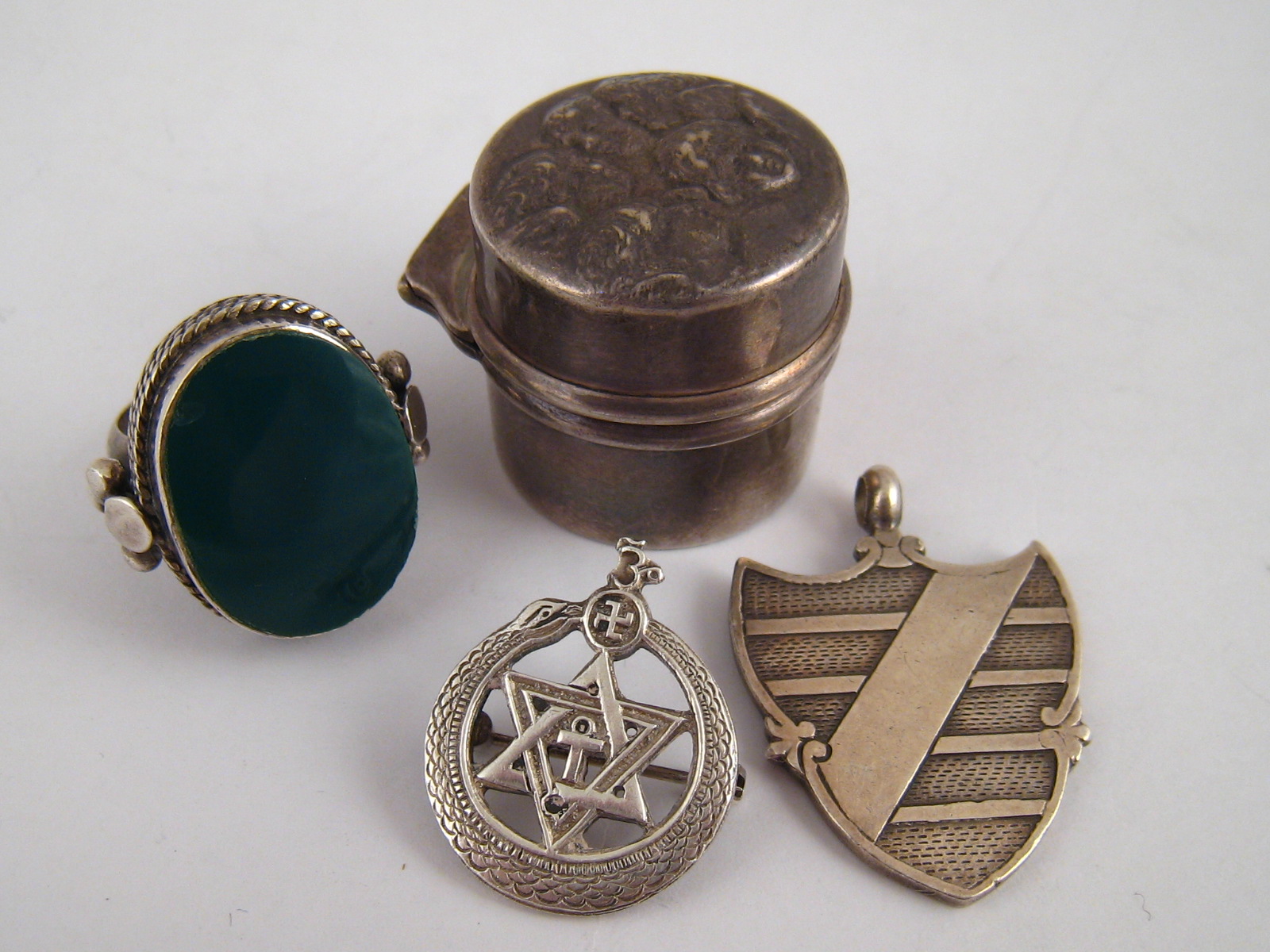 A mixed lot comprising a silver ring box, Birmingham 1903, a silver medallion 1931, a silver badge