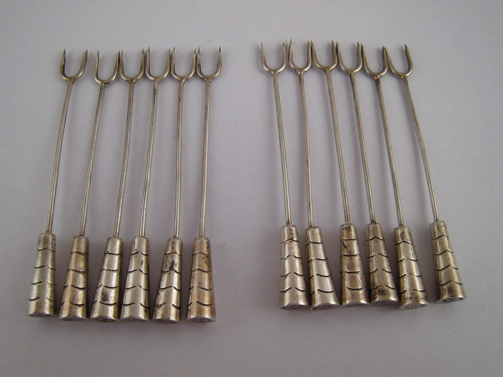 A set of twelve silver snail forks with Art deco handles.