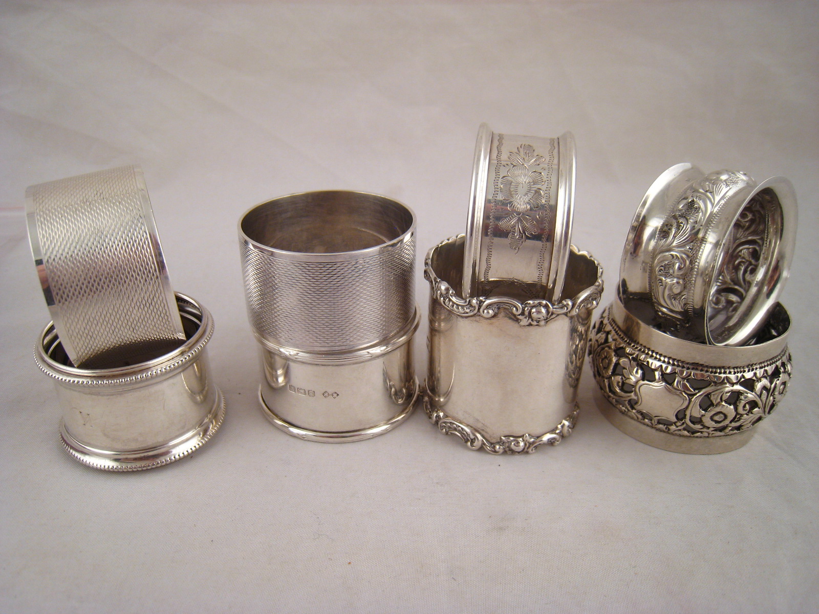 A boxed silver christening set comprising porringer spoon and mug with embossed scenes of Noah's