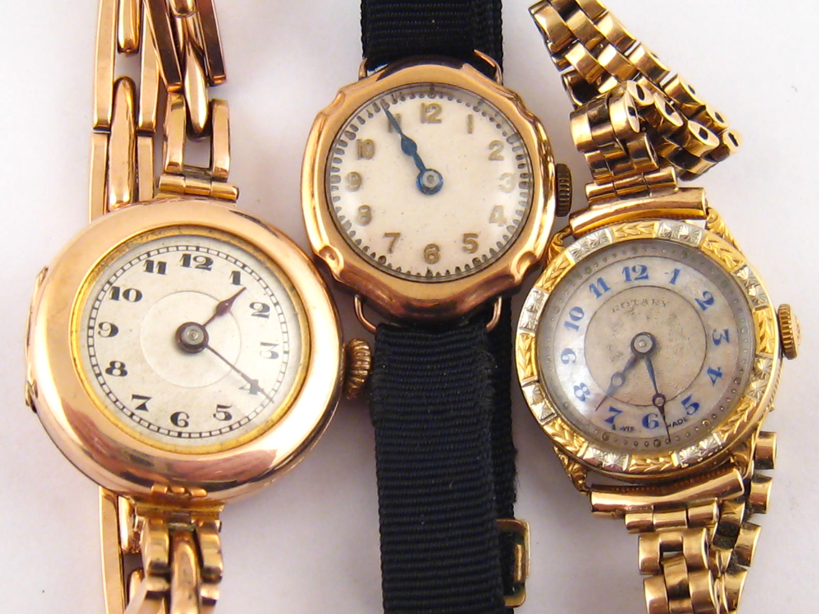 A mixed lot comprising an 18 carat gold lady's wrist watch, circa 1930 with two colour bezel and