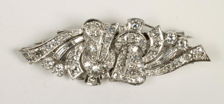 AN ART DECO DIAMOND DOUBLE CLIP BROOCH of stylised scroll form set in platinum with brilliant and