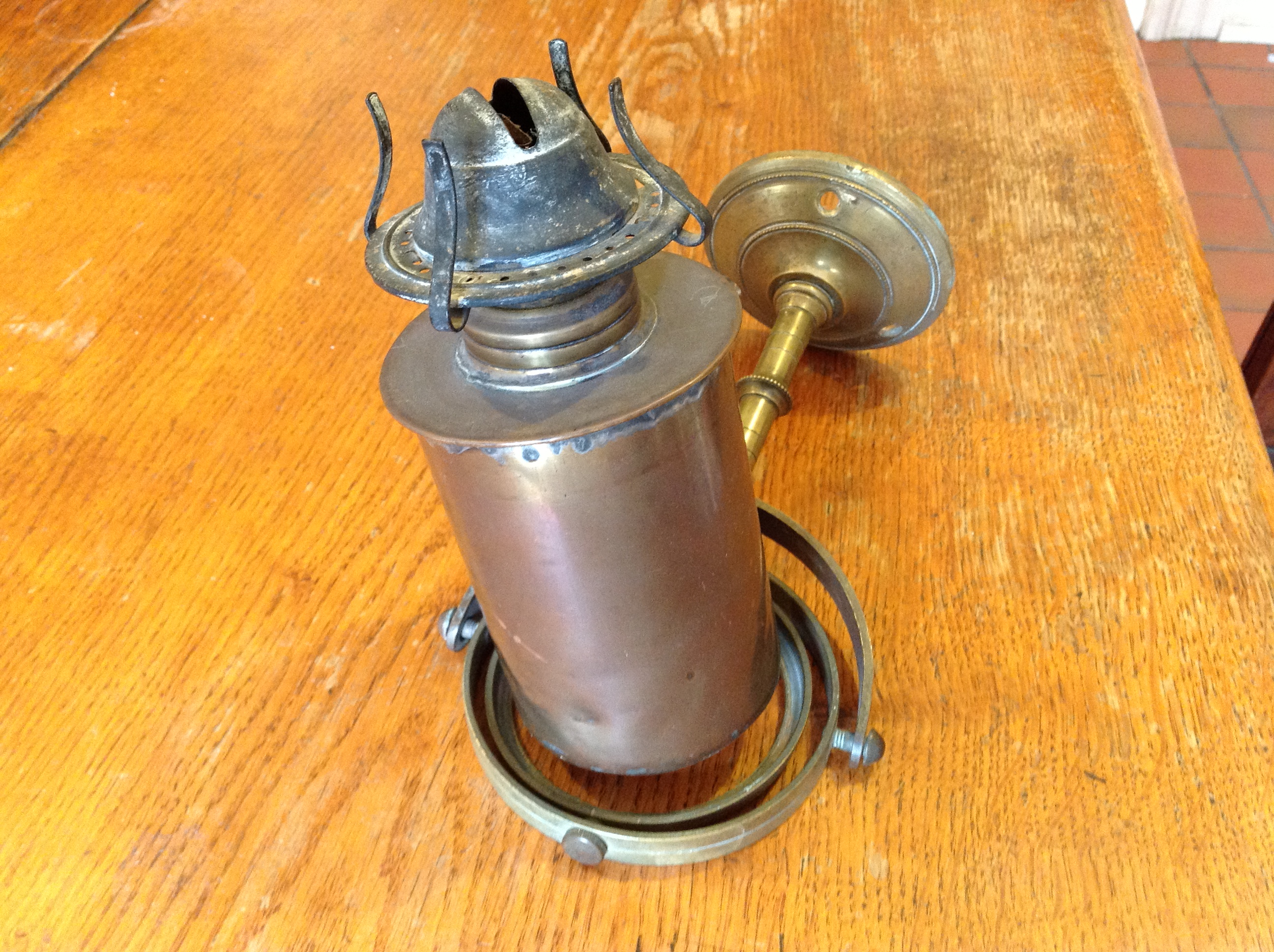 Brass ships` oil lamp mounted in gimbal.