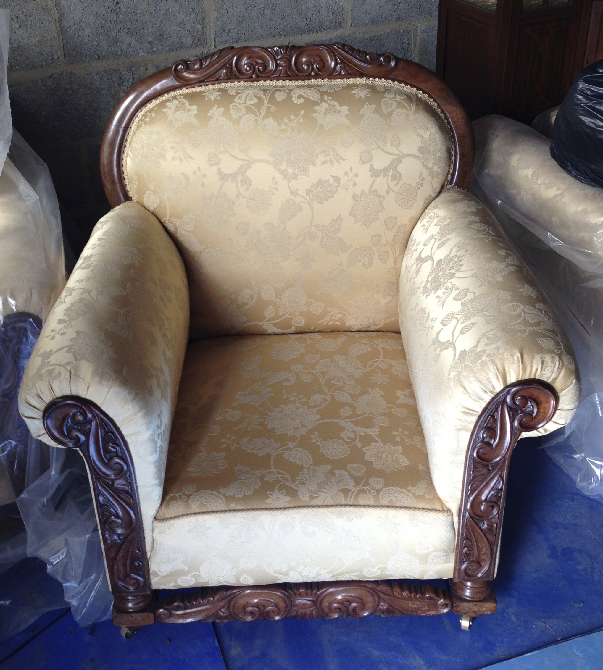 Three piece finely carved, well upholstered suite with footstool.