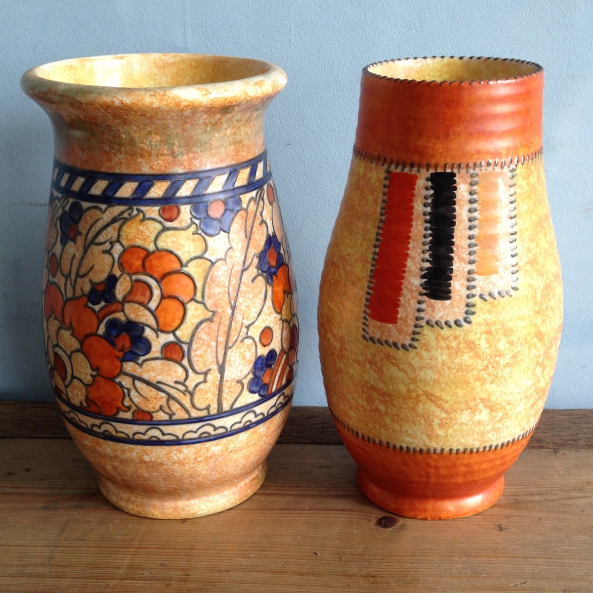 Two Crown Ducal tube lined vases by Charlotte Rhead, one signed.