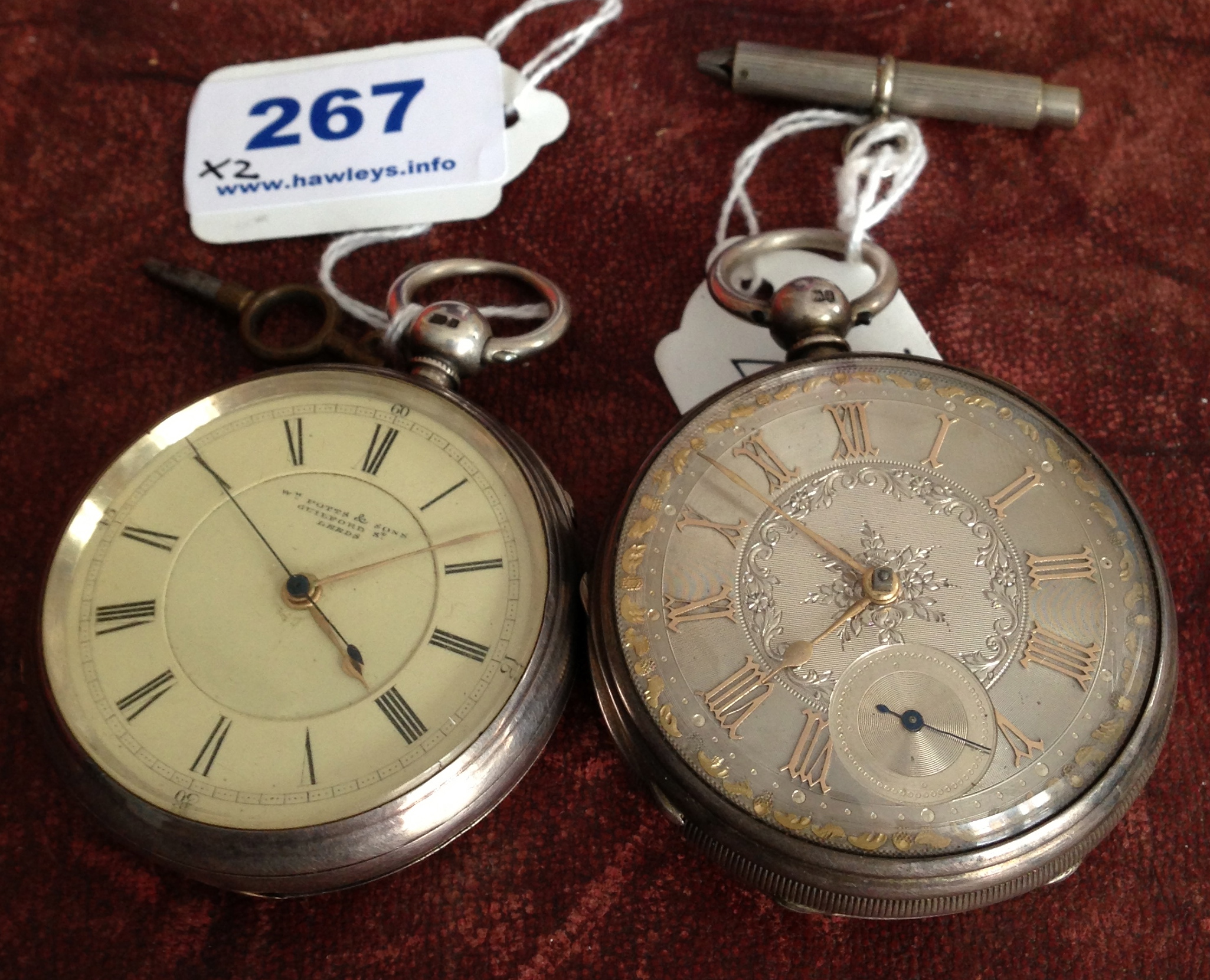 Two silver pocket watches both with keys
