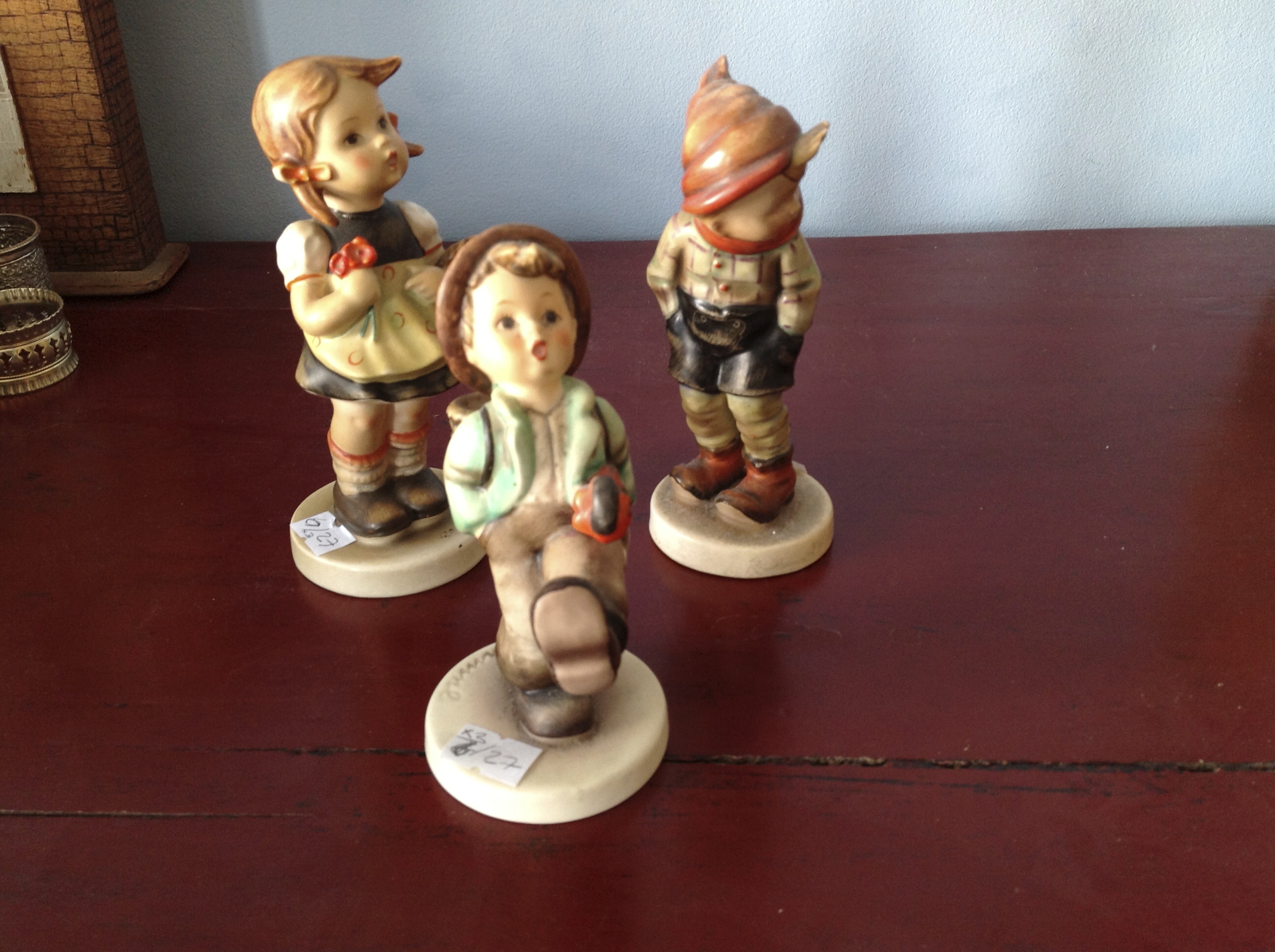 Three Hummel figures.