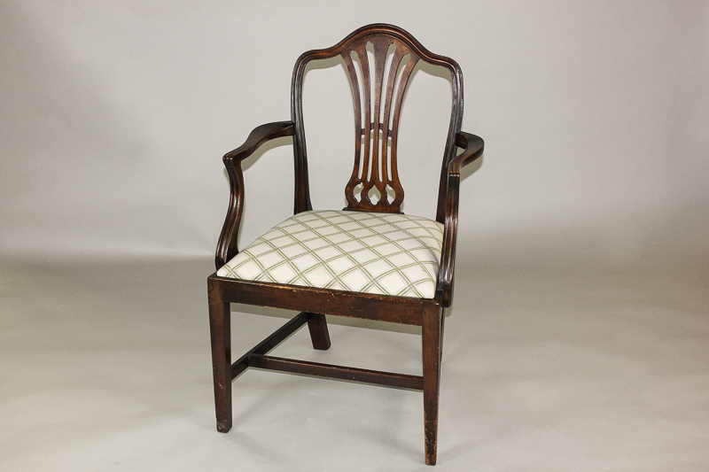 A George III mahogany framed elbow chair with fretted back splat on square tapered legs