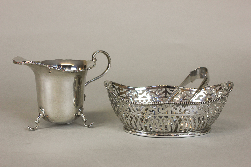 A silver cream jug, Birmingham 1945; together with a small oval silver bon bon dish, Birmingham 1926