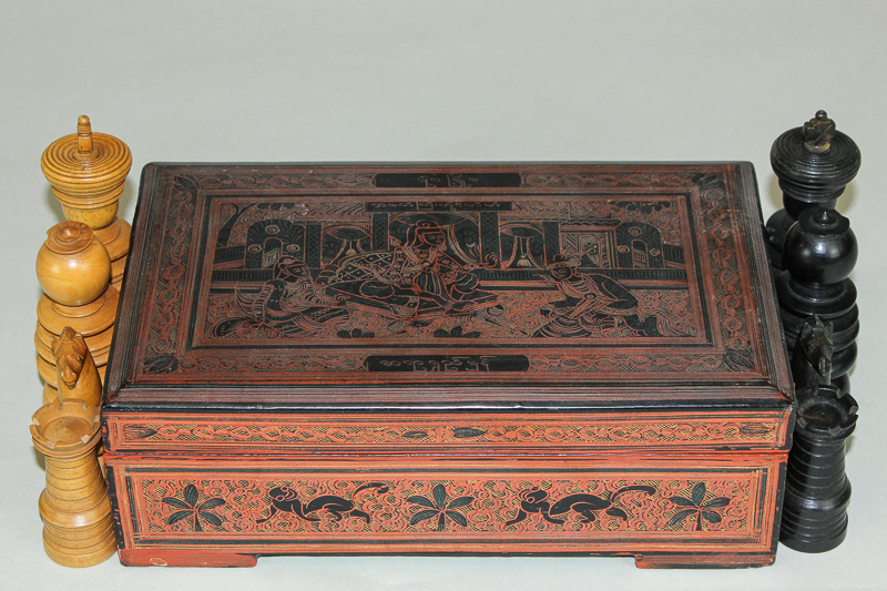 A carved ebony and sandalwood chess set in Chinese lacquered and decorated box, King 11cm high