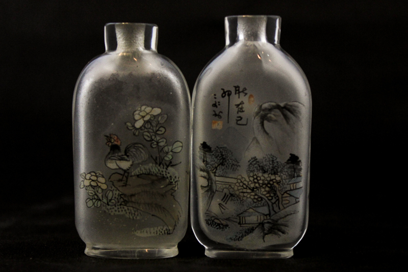 Two Chinese clear glass snuff bottles each with interior painted decoration of fisherman and