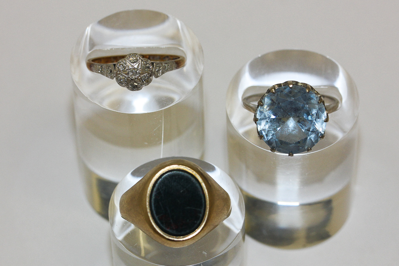 An illusion set diamond ring; a 9ct gold and bloodstone signet ring and a silver dress ring