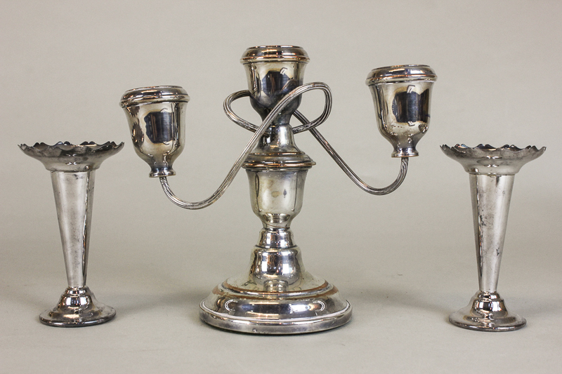 A pair of plated bud vases and a plated three light candelabra with scroll shaped branches