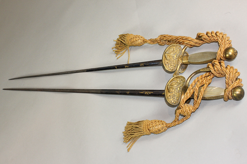 Two French Officers` dress swords with decorated `triangular` blades and gilt guards and hilts