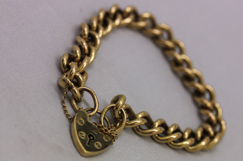 A 9ct gold curb link bracelet with padlock clasp, 32.2gms