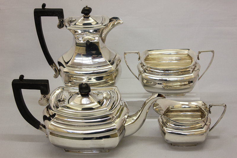 A four piece plated tea set with rectangular bodies comprising tea pot, hot water jug, sugar bowl