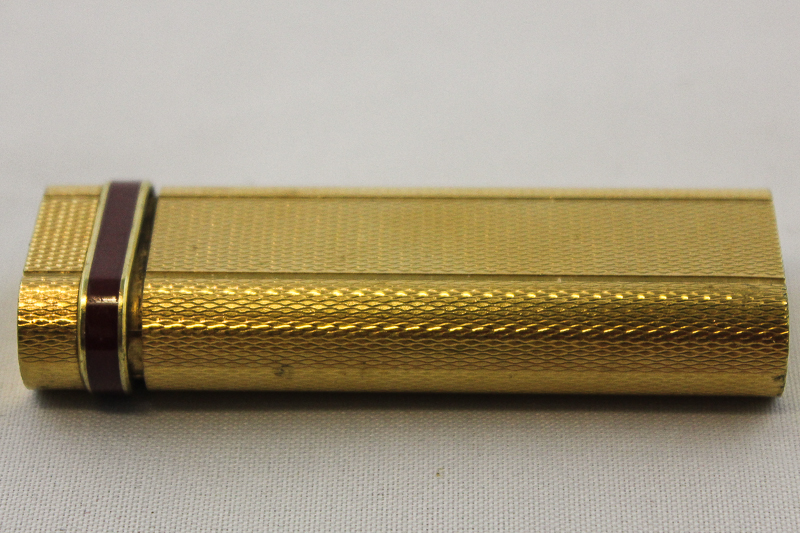 A Cartier gilt cigarette lighter (af)