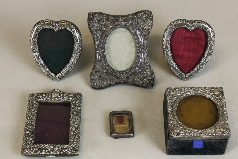 Five various small silver embossed photograph frames