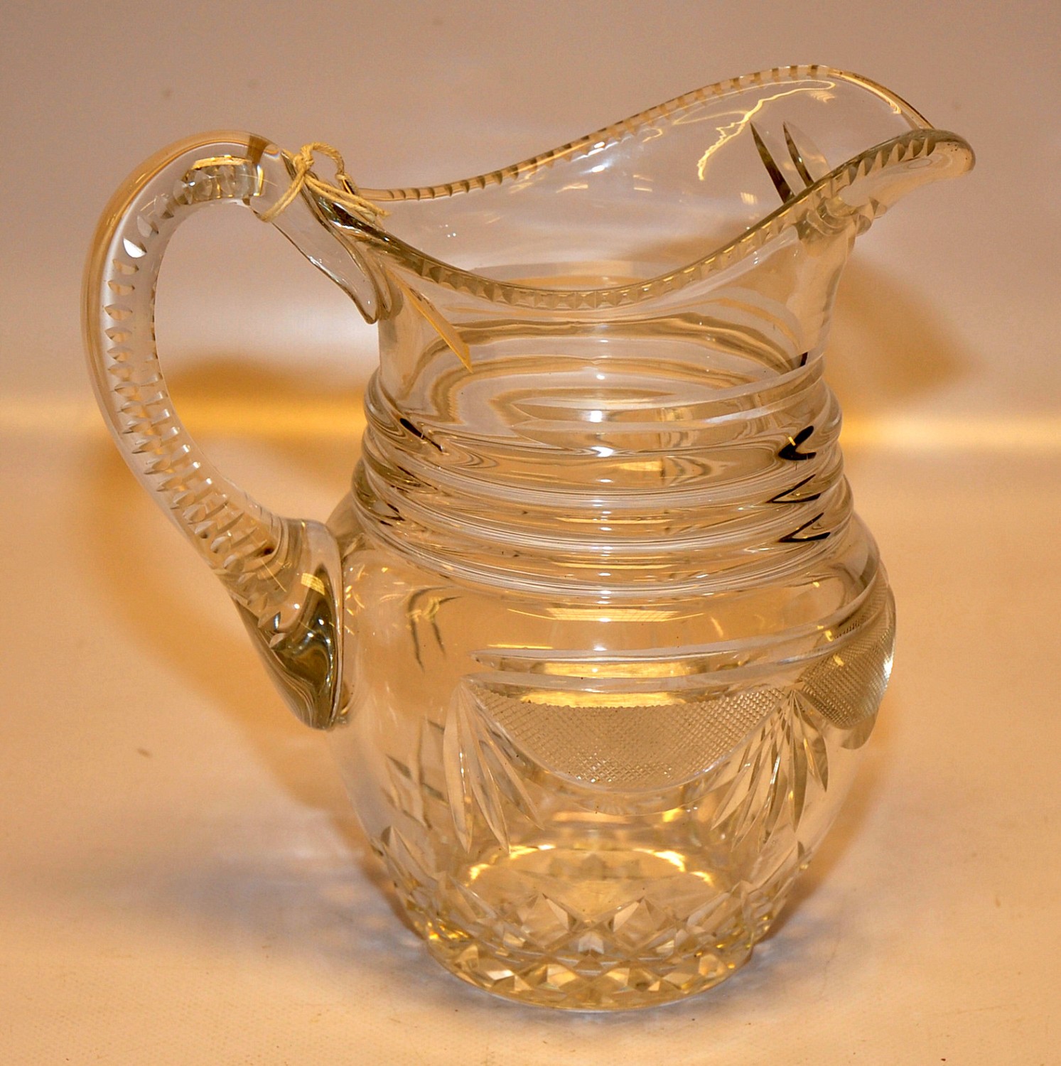 AN EARLY C19TH GLASS JUG