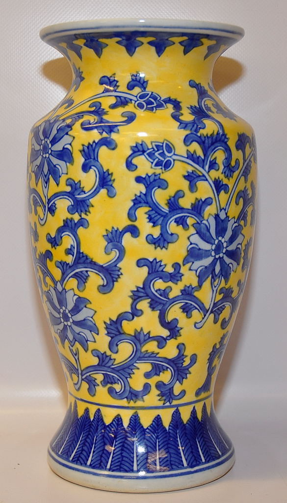 A CHINESE VASE DECORATED IN BLUE WITH BRANCHES OF FLOWERS, A YELLOW GROUND, 29CM
