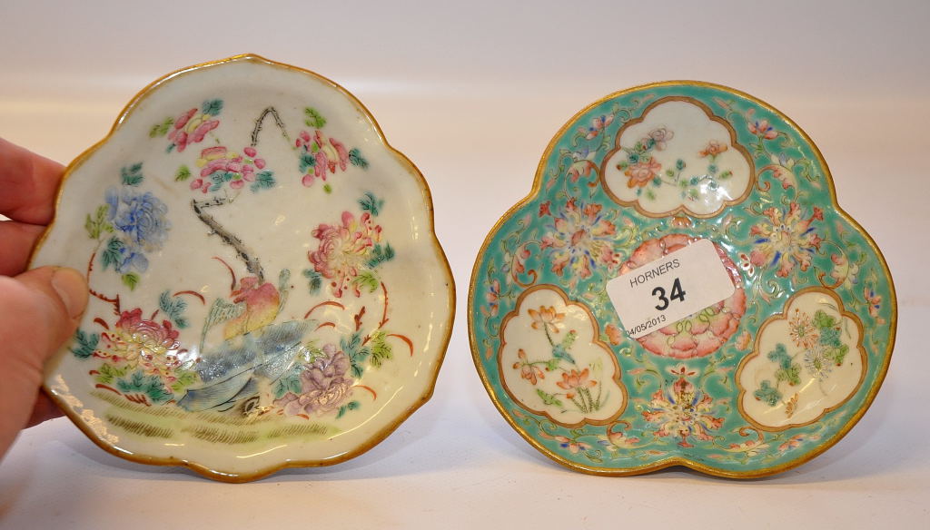 A CHINESE TREFOIL DISH ON A RAISED BASE DECORATED IN A FAMILLE ROSE PALETTE, ALONG WITH ANOTHER WITH