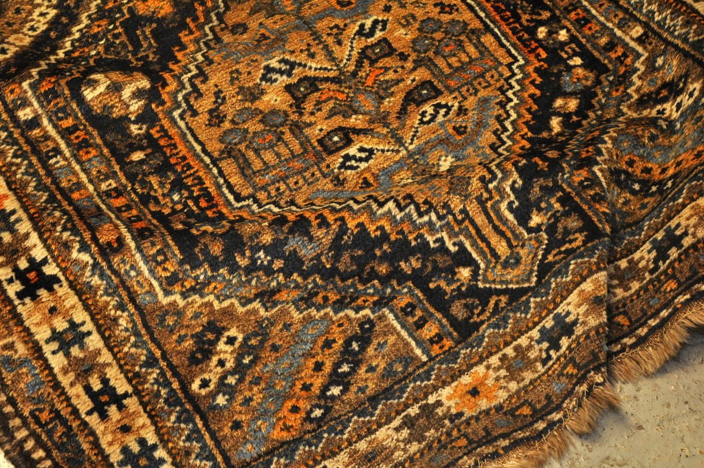 A SHIRAZ RUG WITH CENTRAL STEPPED AND HOOKED LOZENGES