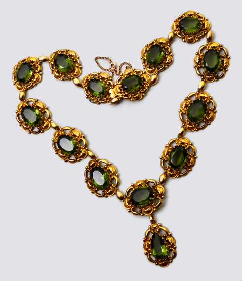 A mid 19th century riviere necklace, the open-work repousse links, with mixed cut green paste stones