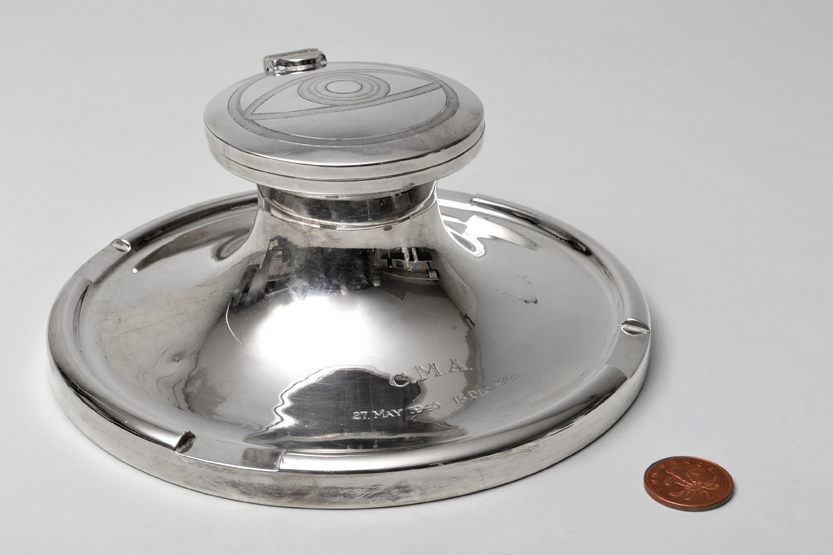 An early 20th century massive silver capstan inkwell, with presentation date and monogram and "All