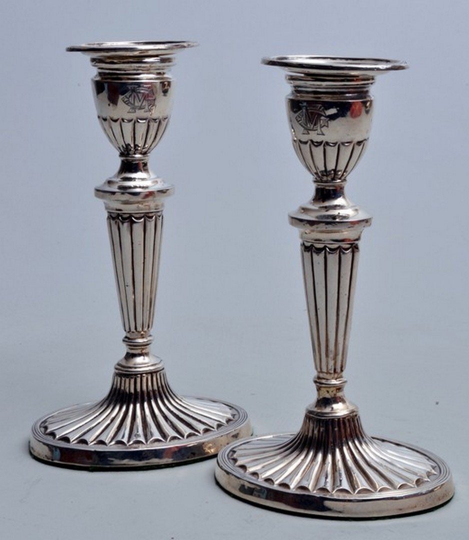 A pair of early 20th century Asprey of London silver table candlesticks, of half reeded Adam design,