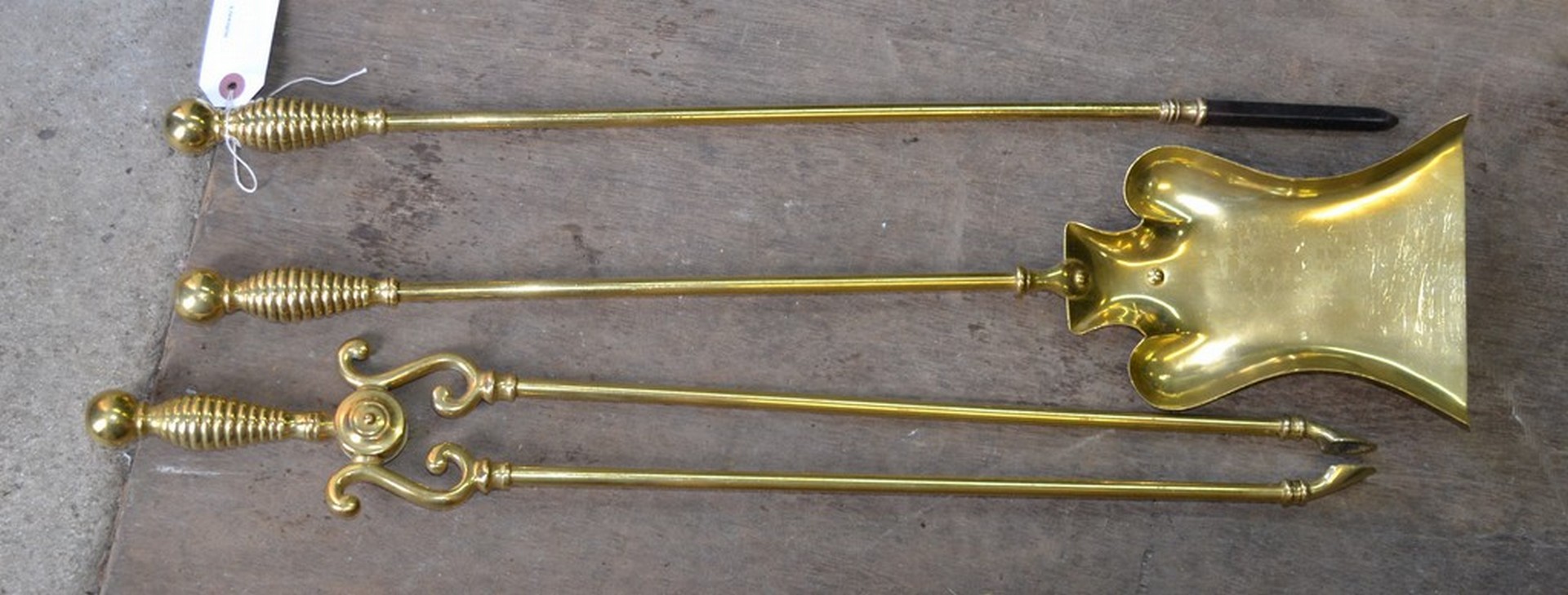 A set of three Georgian design brass fire irons, comprising poker, shovel and tongs
