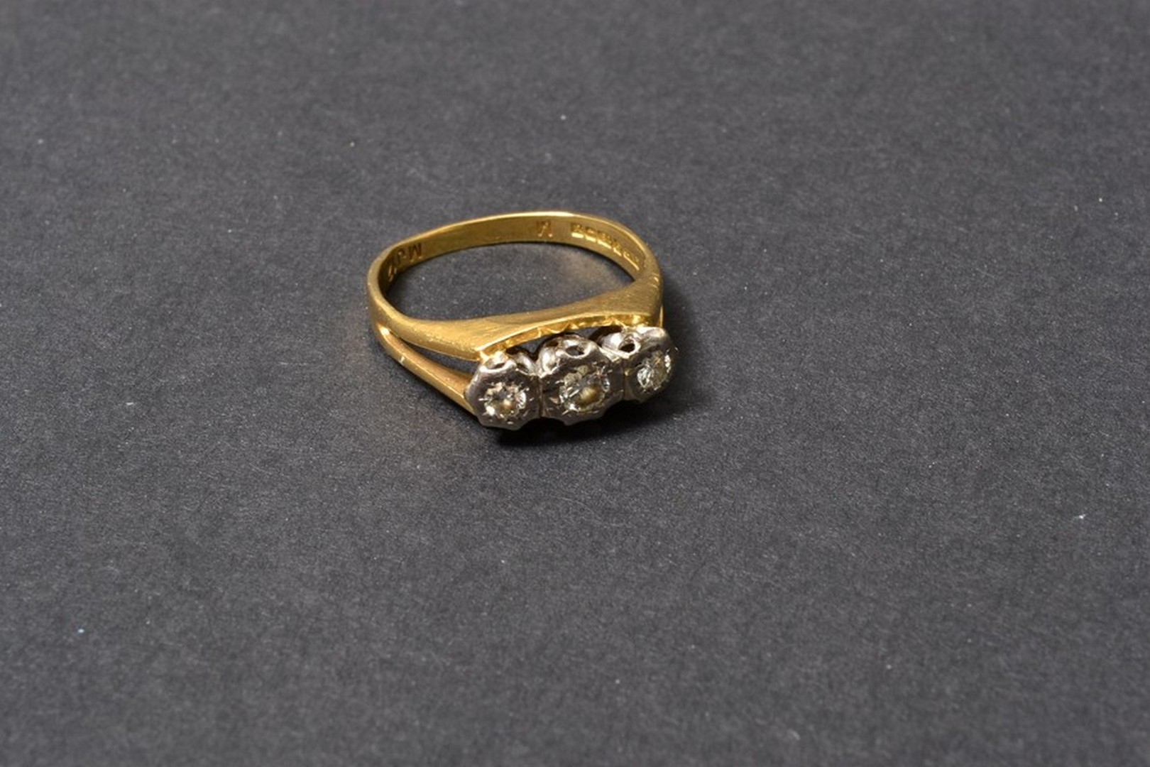 A three stone diamond ring, the single-cut stones in illusion setting, 18ct gold mount