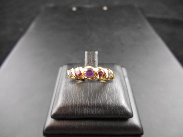 A 9ct gold multi-stone ring in wave setting, size O 1/2 - approx gross weight 2.2g