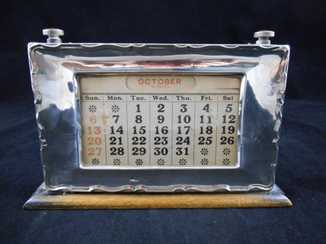 A silver mounted perpetual calendar, Birmingham 1902, maker WJ Myatt & Co. - W21cm