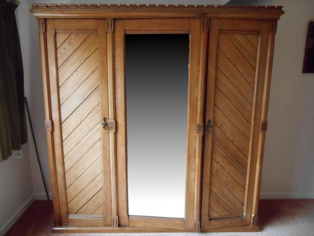 A 19th century Gothic style ash wardrobe, right hand section fitted with slides and drawers, left