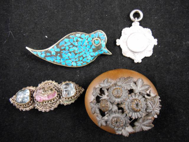 A Chinese white metal wirework brooch set with three carved stones, a white metal bird brooch