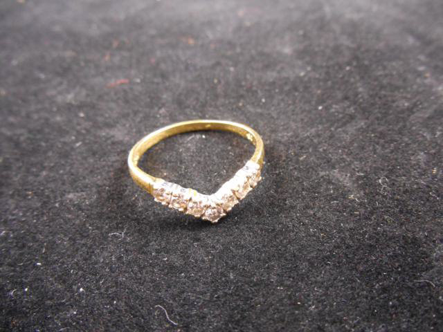 A .750 gold wishbone ring, set with seven diamonds, ring size W - approx gross weight 2.9g