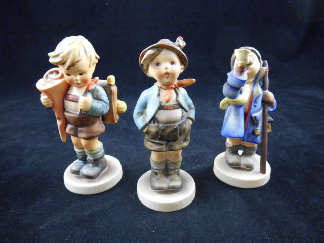 Three Goebel Hummel figures - schoolboy, boy with lantern and pipe and boy with hands in pockets